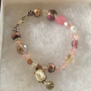 Pink/gold crystal bracelet that says “HOPE”